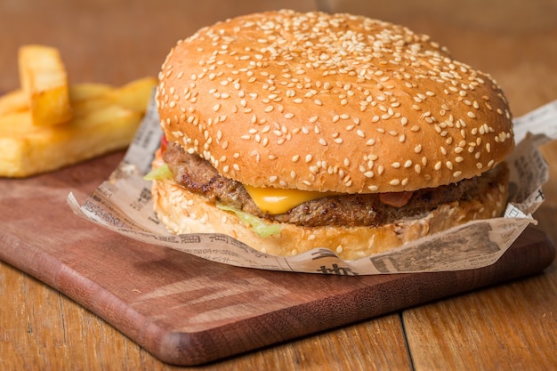 Delicious burger with beef, tomato, cheese and lettuce