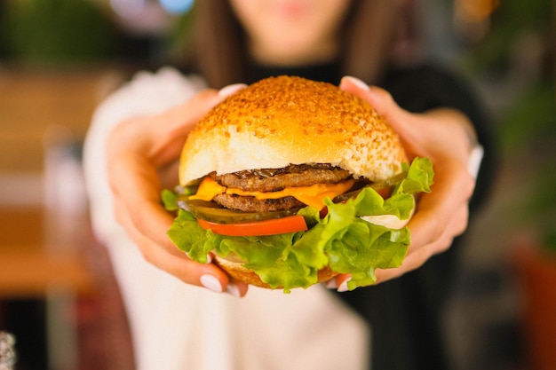 Delicious burger with grilled beef meat vegetables sauce Fast food and junk food concept