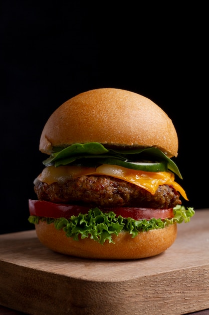 Delicious burger on wooden board