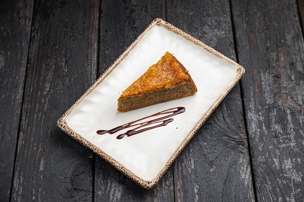 delicious cake with cream on a wooden background