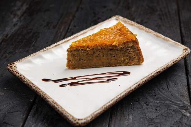 delicious cake with cream on a wooden background