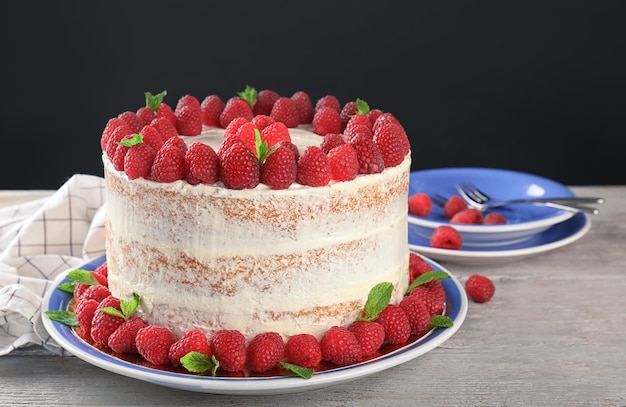 Delicious cake with raspberries on plate