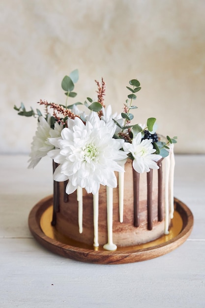 Delicious cake with white and brown chocolate swirly with flowers