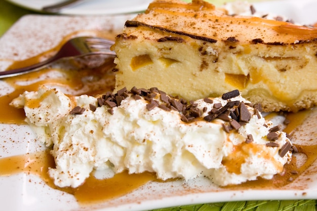 Delicious cheese pie with whipped cream and caramel