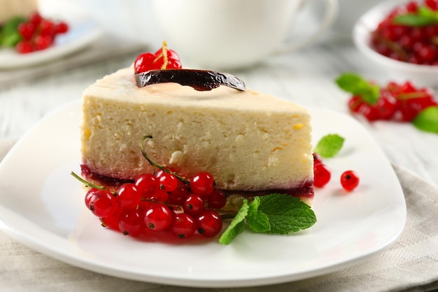 Delicious cheesecake with berries on table close up