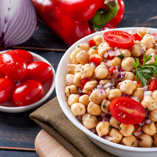 Delicious chickpea salad with tomatoes, onions, peppers and parsley