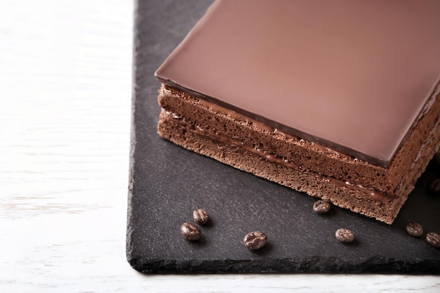 Delicious chocolate cake on cutting board closeup