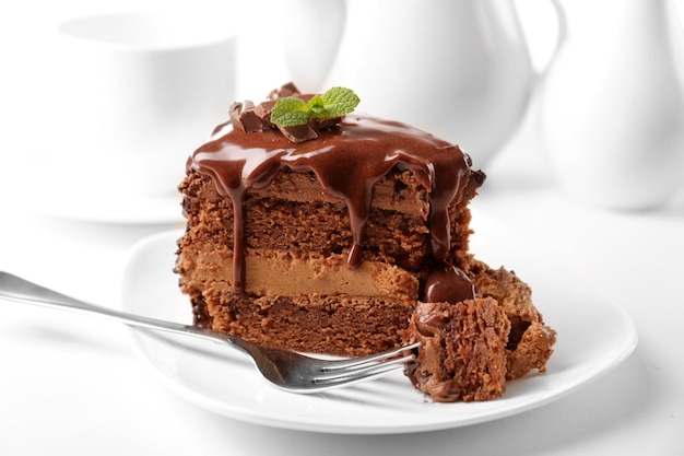 Delicious chocolate cake on plate on table on light background