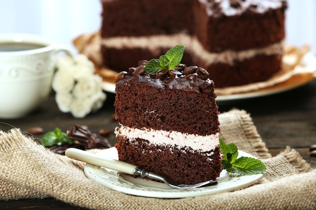 Delicious chocolate cake on table closeup