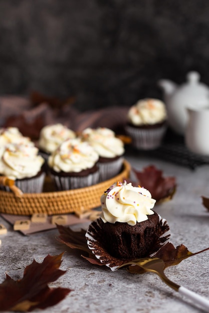 Delicious chocolate cupcake with a cream cap and orange sprinkles Autumn dish