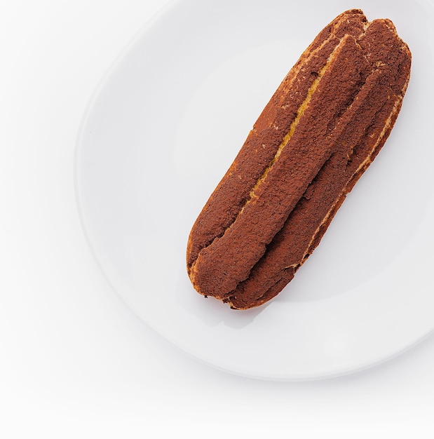 delicious chocolate French eclair on plate