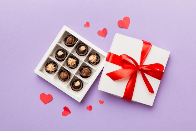 Delicious chocolate pralines in red box for Valentine's Day Heart shaped box of chocolates top view with copy space