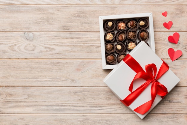 Delicious chocolate pralines in red box for Valentine's Day Heart shaped box of chocolates top view with copy space