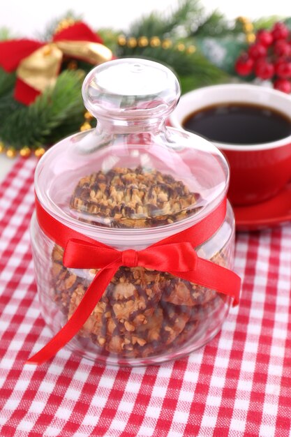 Delicious Christmas cookies in jar on table close-up