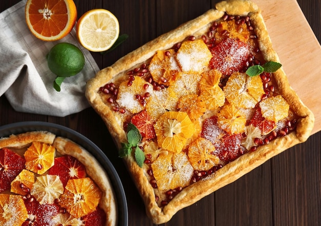 Delicious citrus cakes on pan and cutting board