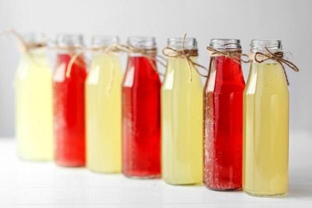 Delicious citrus and pomegranate lemonade in glass bottles Concept of drinks summer bar