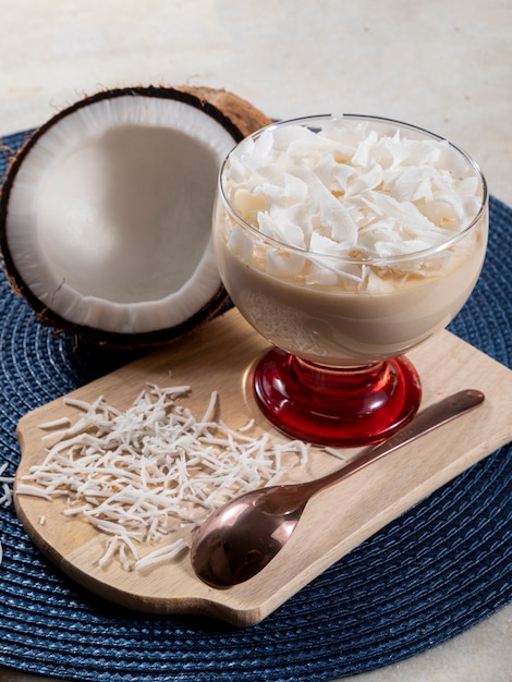 Delicious coconut mousse in glass cup.