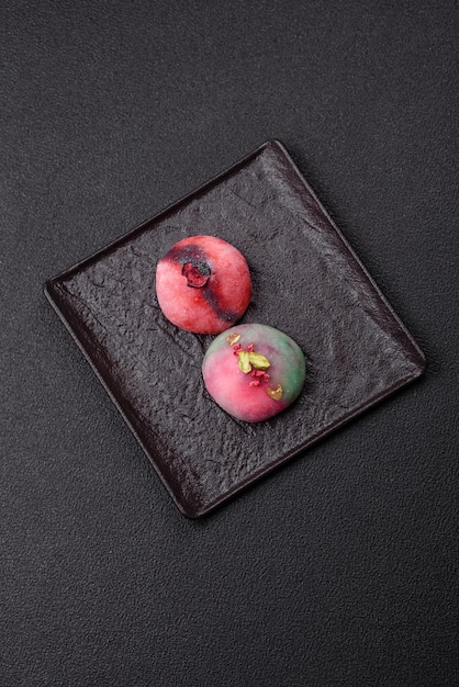 Delicious cold Japanese mochi dessert with colorful rice dough shell and fruit filling