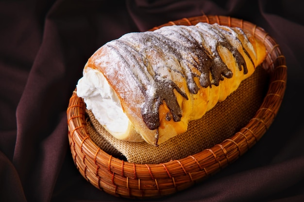 Delicious coneshaped bread rolled up filled with pastry cream covered in homemade chocolate