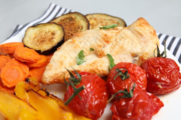 Delicious cooked chicken and vegetables on plate closeup Healthy meals from air fryer