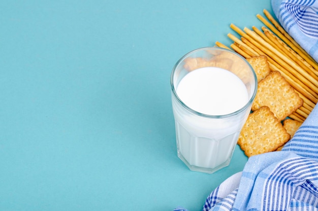 Delicious cookies and glass of milk on bright background. Studio Photo