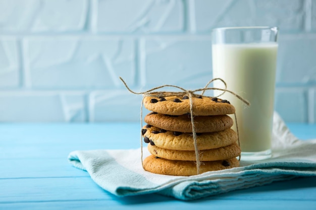 Delicious cookies with chocolate chips on a colored background