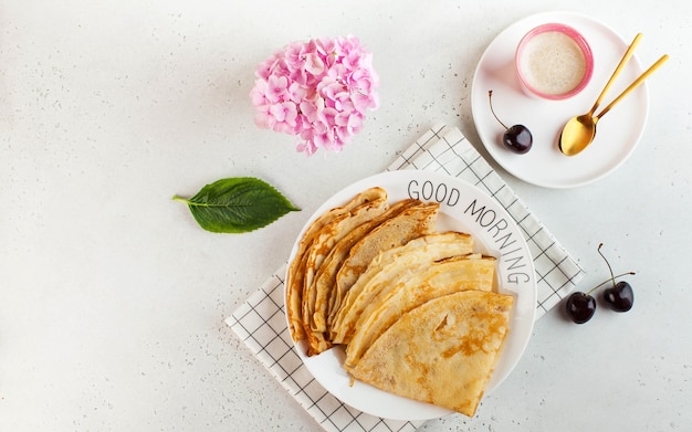 Delicious crepes on plates, coffee mugs. Concept of Breakfast, dessert, recipe, Good morning.