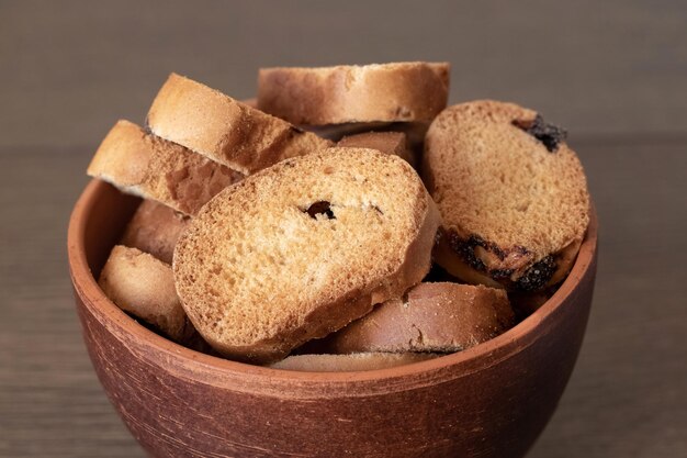 Delicious crispy crouton in a brown plate on a wooden table