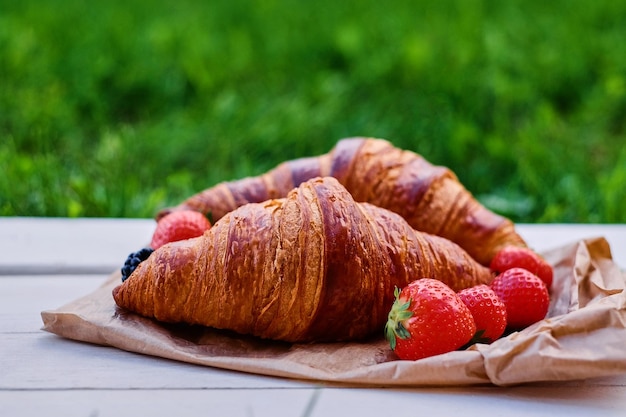 Delicious croissant with strawberry. Close up image