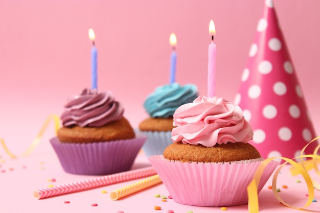 Delicious cupcake with a candle on a colored background with space to insert text. Festive background, birthday. High quality photo