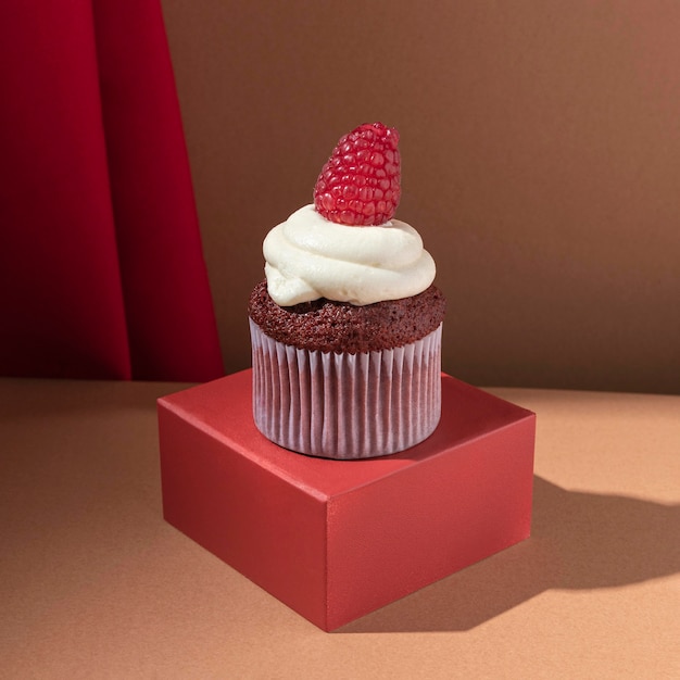 Delicious cupcake with raspberry