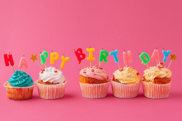 Delicious cupcakes with candles on a colored. Festive, birthday 