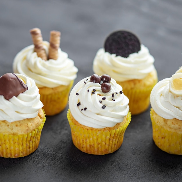 Delicious cupcakes with delicate cream and sweets Square Concept for food bakery menu desserts