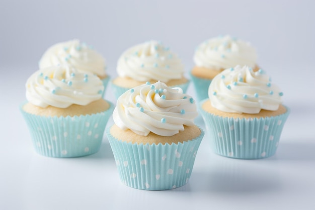 Delicious cupcakes with white frosting and blue polka dots