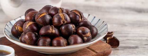 Delicious cut roasted chestnuts with oil and sugar, healthy eating snack in life, close up.