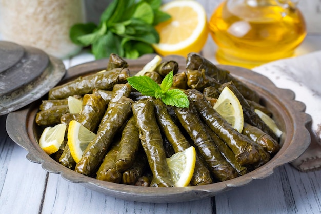 Delicious dolma (sarma) stuffed grape leaves rice. Lebanese dolma sarma on plate. Lebanon turkish greek middle eastern cuisine. (Turkish name; Yaprak sarma)