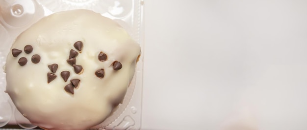 Delicious donut with icing sugar and chocolate chips top view banner with a copy of the space on the right