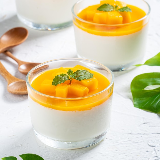 Delicious double colored mango panna cotta mousse pudding on white table background