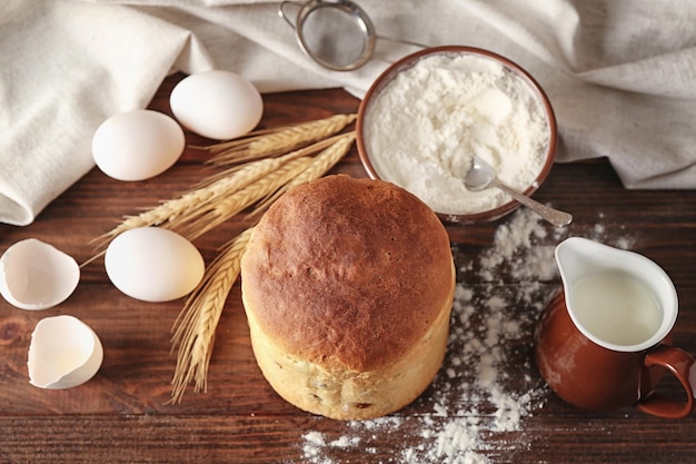 Delicious Easter cake and ingredients on wooden table