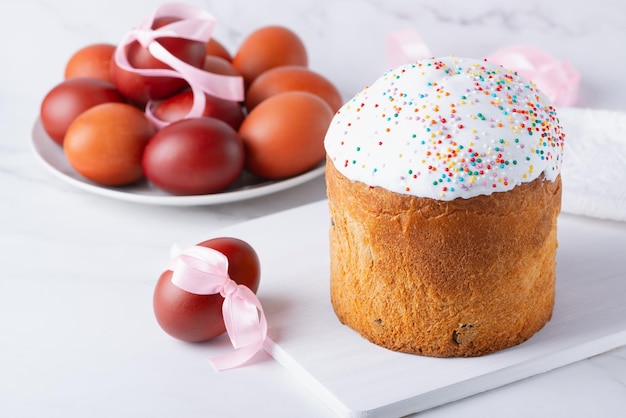 Delicious Easter cakes and eggs on light background