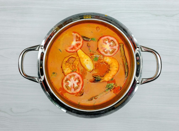 Delicious fish curry stew thai food in bowl on grey background top view