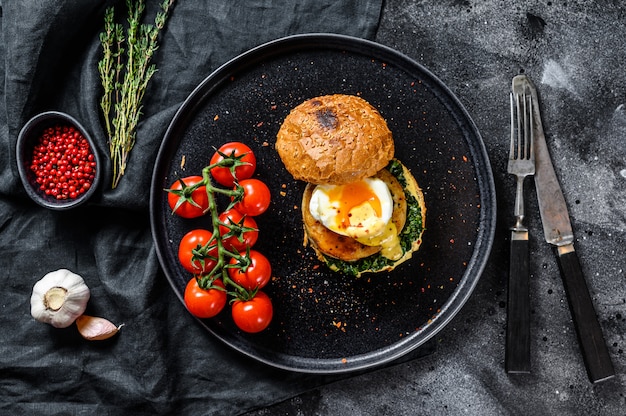 Delicious fishburger with fish fillet, egg and spinach on a brioche bun.