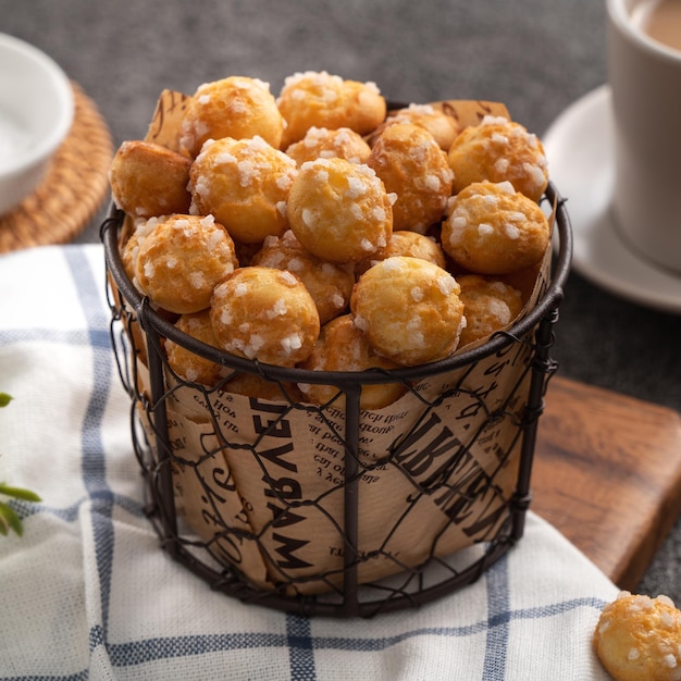 Delicious French Chouquette Choux Pastry dessert Pearl Sugar Puff on gray table background