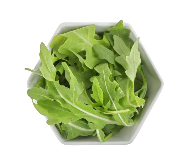 Delicious fresh arugula in bowl isolated on white top view