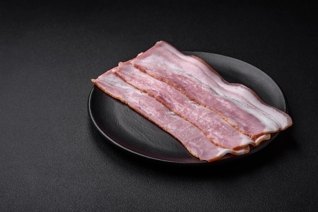 Delicious fresh bacon stripes with spices and salt