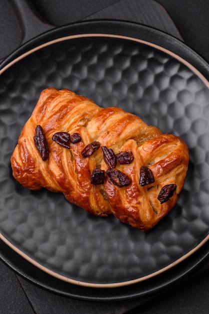 Delicious fresh baked pigtail bun with nuts and syrup