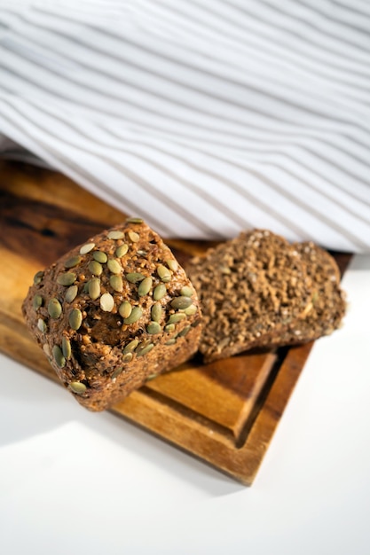 Delicious fresh bread lies on the breakfast table on a white table