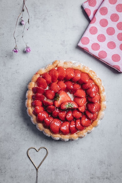 Delicious fresh Charlotte cake with strawberries and Savoiardi biscuits