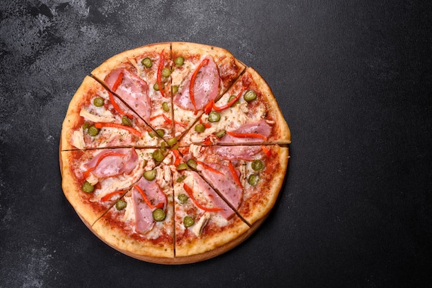 Delicious fresh crispy pizza from the oven with ham and Bulgarian pepper. Italian cuisine