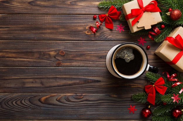 Delicious fresh festive morning coffee in a ceramic cup with little wrapped gifts ornament and xmas toy Cup of coffee and new year toys